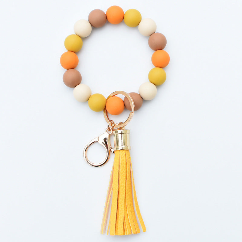 Llavero al por mayor de la muñeca de la borla de la PU del grano del silicón